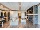 Open-concept living room with a fireplace, exposed beams and hardwood floors at 7201 W Asbury Pl, Lakewood, CO 80227