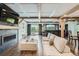 Spacious living room with a fireplace, wet bar and exposed beams at 7201 W Asbury Pl, Lakewood, CO 80227