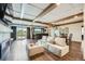 Spacious living room with a fireplace, wet bar and exposed beams at 7201 W Asbury Pl, Lakewood, CO 80227