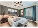 Cozy bedroom featuring gray walls, unique art pieces and hardwood floors at 7201 W Asbury Pl, Lakewood, CO 80227