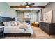 Luxurious main bedroom with wood beam ceiling, fireplace and comfortable furnishings at 7201 W Asbury Pl, Lakewood, CO 80227
