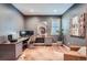 Modern home office with custom desk, wood floors, and ample natural light at 7201 W Asbury Pl, Lakewood, CO 80227