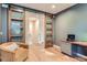 Comfortable sitting area with sliding barn doors and hardwood floors at 7201 W Asbury Pl, Lakewood, CO 80227
