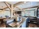Wet bar with plenty of storage and seating adjacent to the living room at 7201 W Asbury Pl, Lakewood, CO 80227