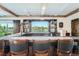 Wet bar with a dark countertop and wood cabinetry at 7201 W Asbury Pl, Lakewood, CO 80227