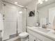 Clean bathroom with a glass-enclosed shower, quartz countertop, and modern fixtures at 4894 Basalt Ridge Cir, Castle Rock, CO 80108