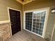 Private patio with dark brown door and sliding glass door at 17346 Nature Walk Trl # 201, Parker, CO 80134