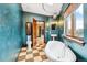 Bathroom features a soaking tub, checkered tile floor, and plenty of natural light with a view of the city at 2150 Curtis St, Denver, CO 80205