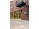 Brick building featuring a garage door style window, exterior lighting, and an awning at 2150 Curtis St, Denver, CO 80205