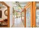 Hallway featuring an ornate mirror, rainbow ceiling beam, and glass doors at 2150 Curtis St, Denver, CO 80205