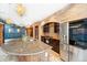 Kitchen featuring brick backsplash, travertine flooring, stainless steel appliances, and eat-in island at 2150 Curtis St, Denver, CO 80205