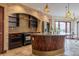 Charming kitchen with brick backsplash, dark wood cabinets, and travertine floors at 2150 Curtis St, Denver, CO 80205