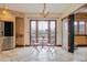Cozy kitchen nook with travertine floors, brick wall, and balcony access at 2150 Curtis St, Denver, CO 80205