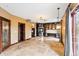 Large living room with built-in shelving, stained glass doors, beautiful chandelier, and view into the bathroom at 2150 Curtis St, Denver, CO 80205