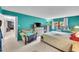Bright bedroom with large window, sitting area, flat screen TV, and neutral carpet at 14300 E Marina Dr # 109, Aurora, CO 80014