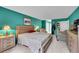 Spacious bedroom featuring hardwood furniture, neutral carpet, and bright teal walls at 14300 E Marina Dr # 109, Aurora, CO 80014