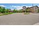 Exterior view of a modern building featuring a central tower, complemented by landscaped grounds and a welcoming entrance at 14300 E Marina Dr # 109, Aurora, CO 80014