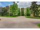 Apartment building exterior with well-maintained landscaping and a paved driveway entrance at 14300 E Marina Dr # 109, Aurora, CO 80014