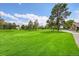 Scenic view of the golf course with lush green grass and mature trees under a bright sky, offering a serene and recreational setting at 14300 E Marina Dr # 109, Aurora, CO 80014