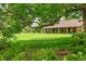 Scenic view of a golf course with a putting green and clubhouse framed by lush foliage at 14300 E Marina Dr # 109, Aurora, CO 80014