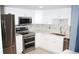 Modern kitchen featuring stainless steel appliances, sleek countertops, and bright white cabinetry at 14300 E Marina Dr # 109, Aurora, CO 80014