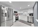 Modern kitchen featuring stainless steel appliances, sleek white cabinets, and marble backsplash at 14300 E Marina Dr # 109, Aurora, CO 80014