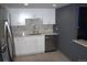 Modern kitchen with white cabinets, stainless steel appliances and marble backsplash and countertops at 14300 E Marina Dr # 109, Aurora, CO 80014
