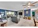 Comfortable living room featuring a ceiling fan, large windows, and inviting seating at 14300 E Marina Dr # 109, Aurora, CO 80014