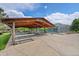Outdoor pavilion with picnic tables, adjacent to a golf parking area and tennis courts at 14300 E Marina Dr # 109, Aurora, CO 80014