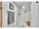 Modern shower with glass enclosure, tiled walls, and updated fixtures at 14300 E Marina Dr # 109, Aurora, CO 80014