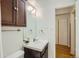 A practical bathroom with a functional vanity, overhead lighting, and a view of the hallway at 555 E 10Th Ave # 214, Denver, CO 80203