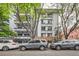 Exterior view of apartment building with multiple balconies and street parking at 555 E 10Th Ave # 214, Denver, CO 80203