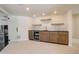 Modern wet bar with sleek cabinetry and a beverage refrigerator at 5268 Talavero Pl, Parker, CO 80134