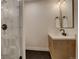 Basement bathroom with a modern vanity, hexagonal tile floor, and glass shower at 5268 Talavero Pl, Parker, CO 80134