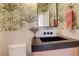 Stylish powder room with unique wallpaper, modern vanity, and black sink at 5268 Talavero Pl, Parker, CO 80134