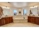 Large bathroom with double vanity, soaking tub, and natural light at 5268 Talavero Pl, Parker, CO 80134