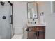 Modern bathroom with dark wood vanity, walk-in shower, and white toilet at 5268 Talavero Pl, Parker, CO 80134