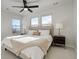 Main bedroom with neutral decor, large bed, and ceiling fan at 5268 Talavero Pl, Parker, CO 80134