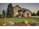 Two-story house with stone accents and landscaping at 5268 Talavero Pl, Parker, CO 80134