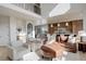 Living area with leather sofas and open kitchen view at 5268 Talavero Pl, Parker, CO 80134