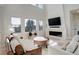 Bright living room with a fireplace and large windows at 5268 Talavero Pl, Parker, CO 80134