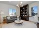 Bright and airy home office with built-in shelving, comfortable seating, and natural light at 5268 Talavero Pl, Parker, CO 80134