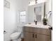 Modern half bathroom features stylish vanity with white countertop, wood cabinets, and elegant fixtures at 2920 W Parkside Pl, Denver, CO 80221