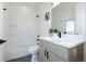 Modern bathroom features a shower-tub combo, with white subway tiles and bright vanity at 2920 W Parkside Pl, Denver, CO 80221