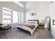 Bright primary bedroom with large windows, neutral decor, and a cozy atmosphere, filled with natural light at 2920 W Parkside Pl, Denver, CO 80221