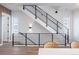 Modern staircase with sleek black metal railings and natural light from nearby windows at 2920 W Parkside Pl, Denver, CO 80221