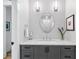Elegant bathroom with a gray vanity, stylish mirror, quartz countertop, and modern fixtures presents refinement at 1002 Detroit St, Denver, CO 80206