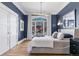 A stylish bedroom features a large window, hardwood floors, and tasteful decor, creating a serene retreat at 1002 Detroit St, Denver, CO 80206