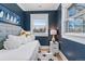 Cozy bedroom features a daybed with soft cushions, natural light, and a playful penguin-themed artwork at 1002 Detroit St, Denver, CO 80206