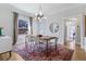 Bright dining room features a modern chandelier and a large window that provides lots of natural light at 1002 Detroit St, Denver, CO 80206